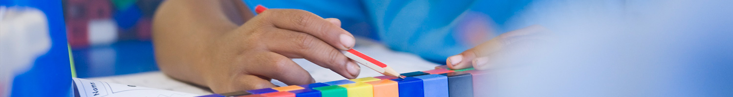 Child counting coloured blocks